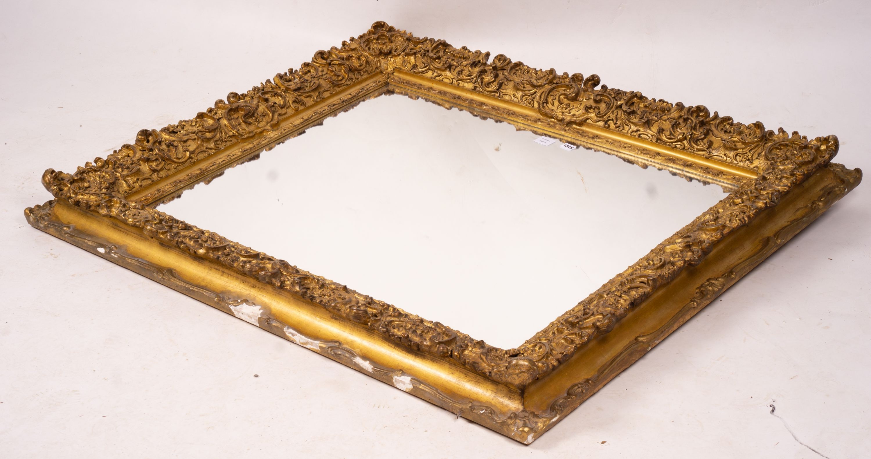 An ornate Victorian giltwood and gesso rectangular wall mirror (formerly a picture frame) width 130cm, height 112cm